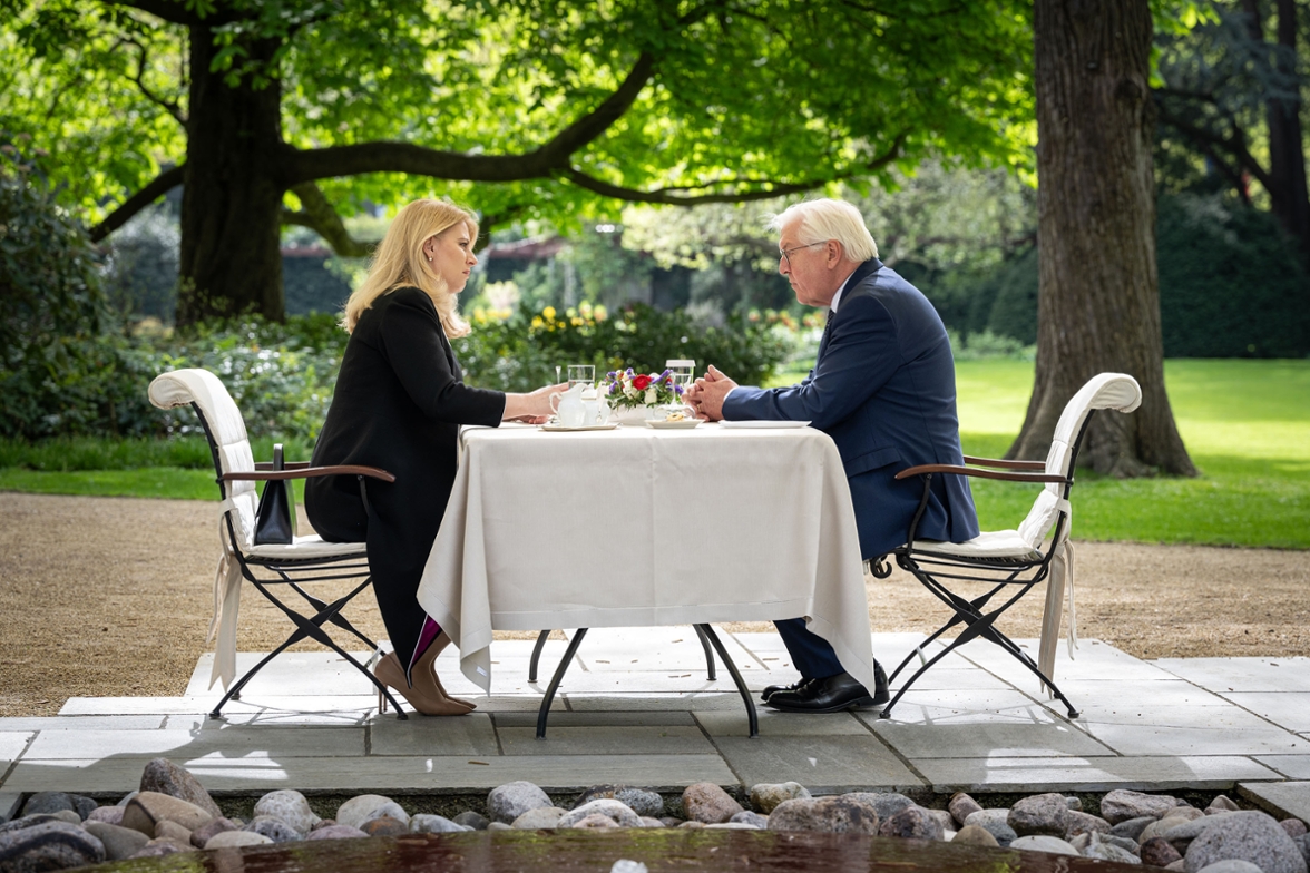 Bundespräsident Frank-Walter Steinmeier und die Präsidentin der Slowakischen Republik, Zuzana Čaputová, sprechen am Tisch im Schlosspark von Schloss Bellevue